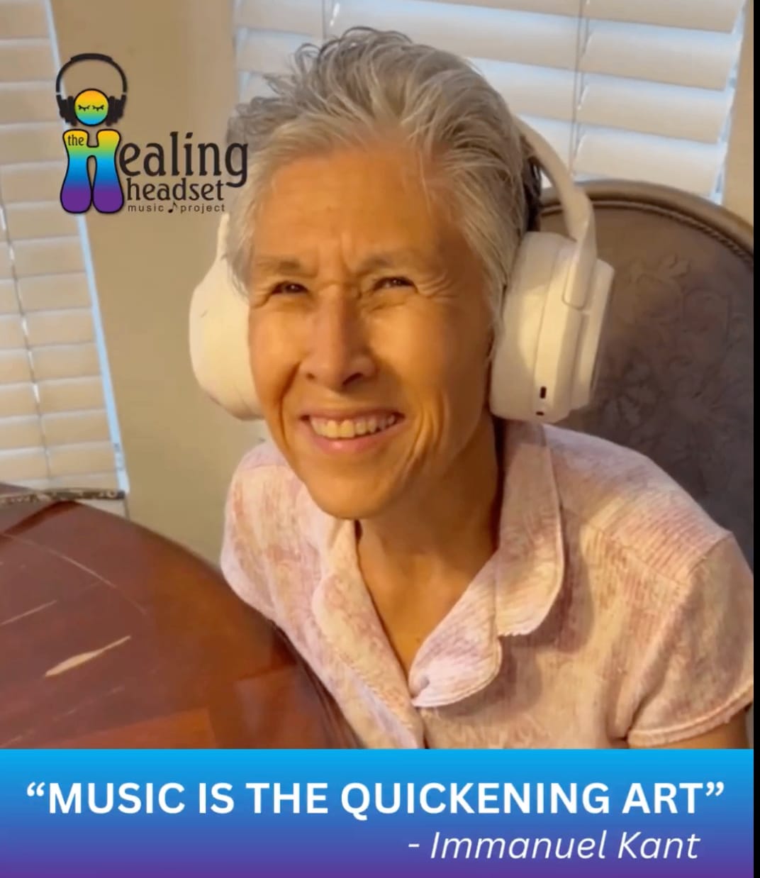 A smiling woman wearing a wireless Healing Headset — a simple, preloaded personalized music player for dementia